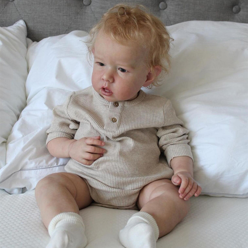 20 inch Paul reborn doll with short blonde hair and open eyes